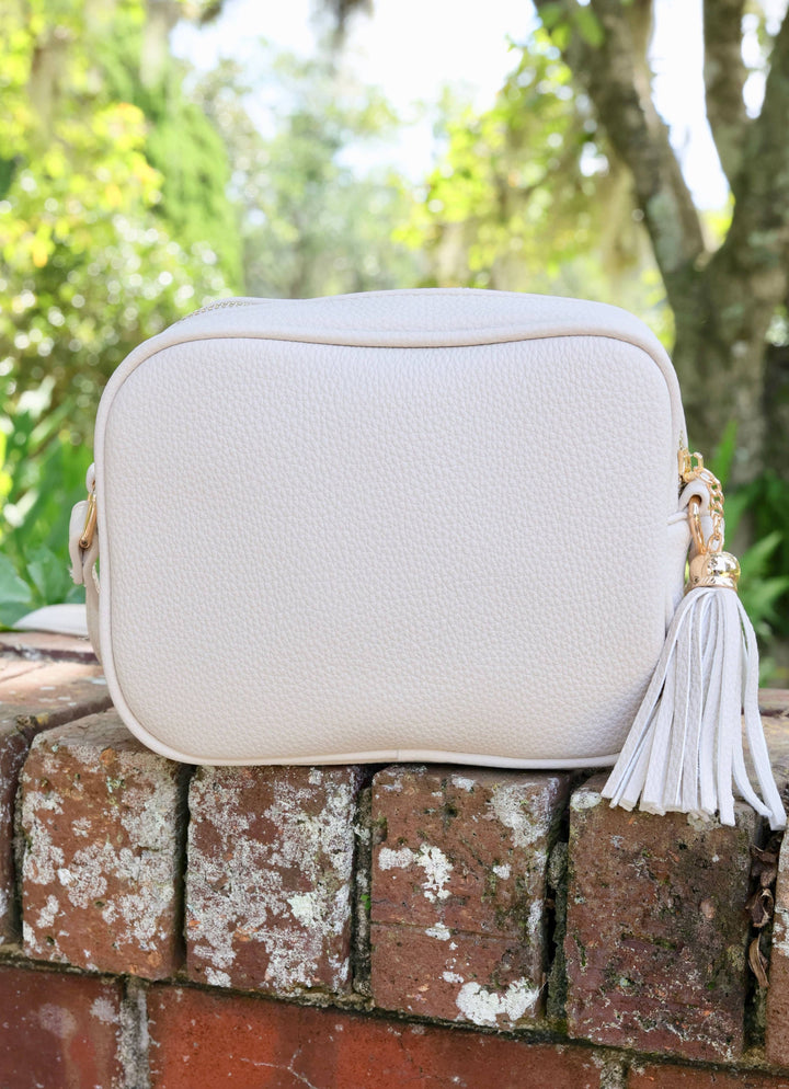 RYLIE VEGAN LEATHER CROSSBODY WITH TASSEL - CREAM