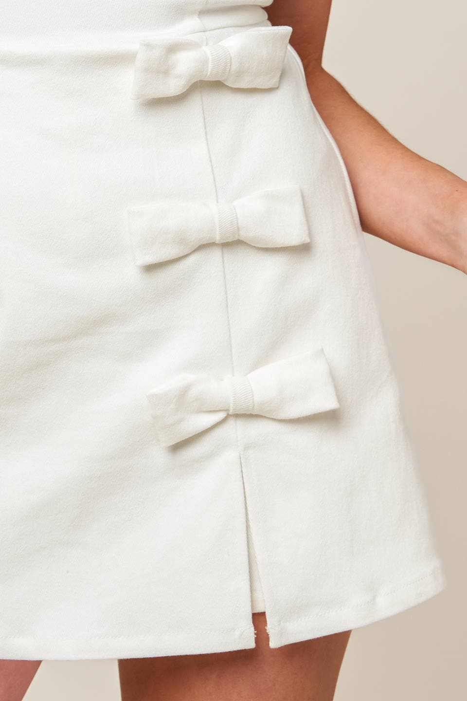 SOLID WOVEN BOW DETAIL SKORT ROMPER - MILK